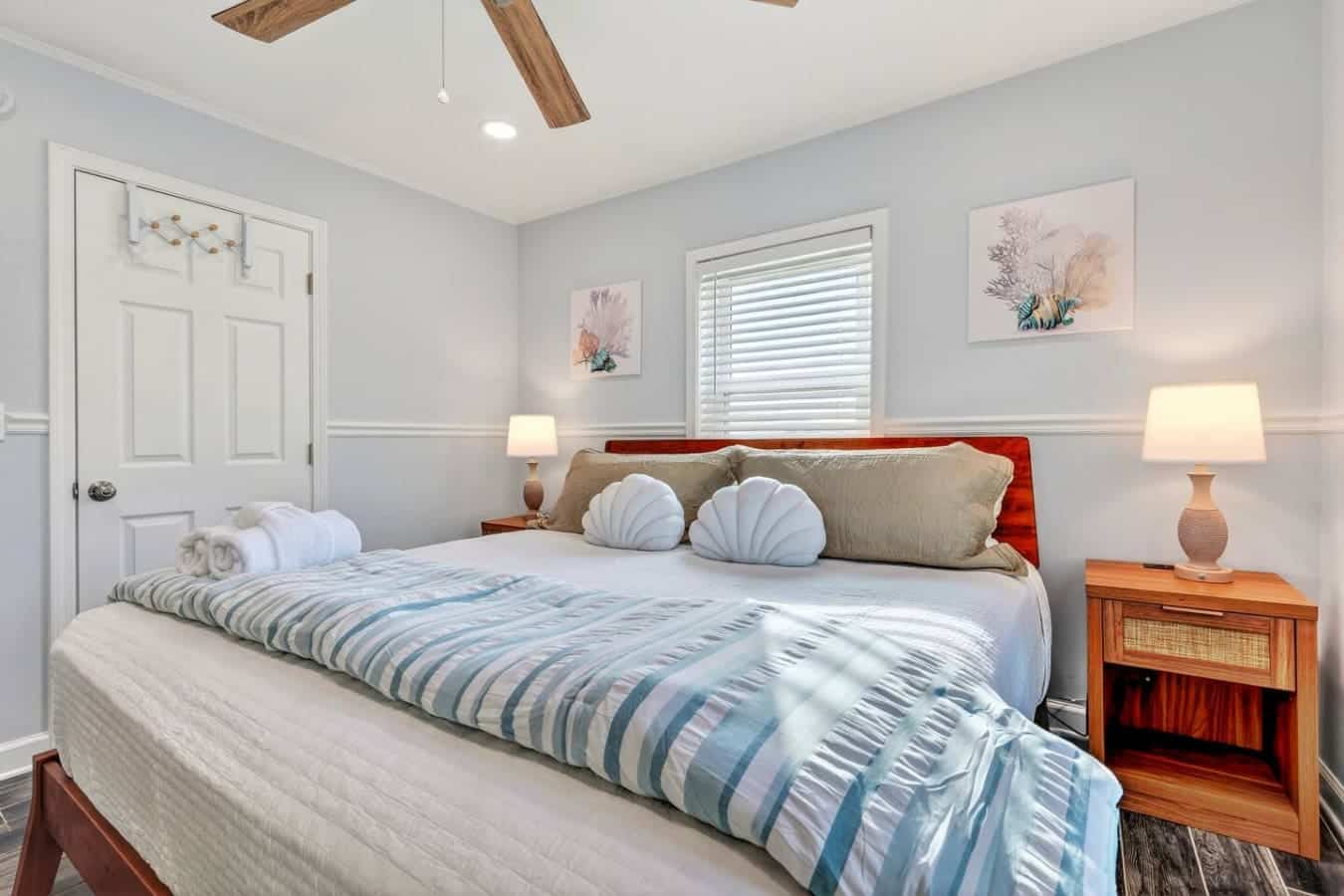 This bright, airy master bedroom features a comfortable king bed, plenty of natural light, and a peaceful coastal vibe.