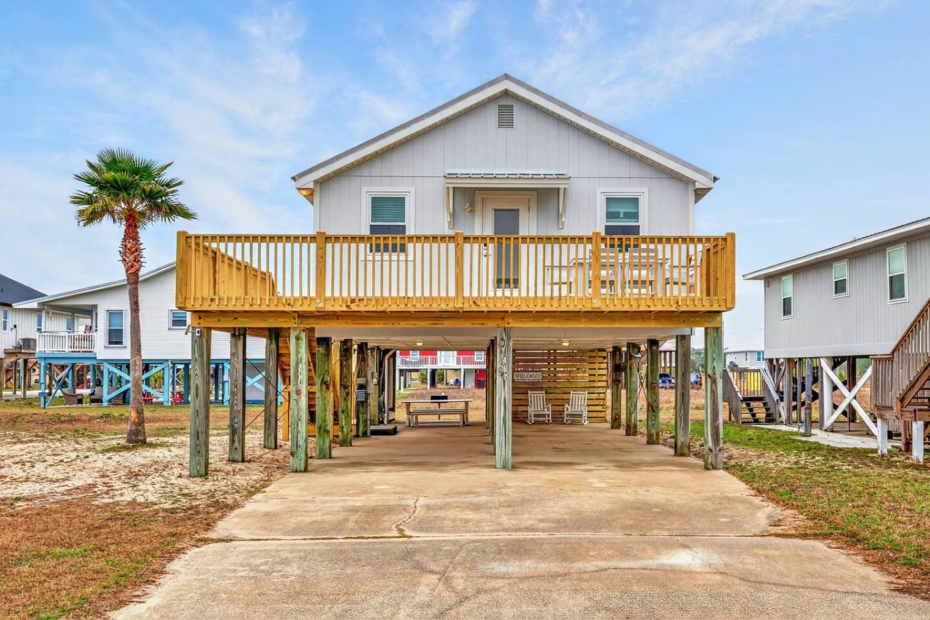 This elevated beach house features a sprawling deck with plenty of covered space and direct sand access for the perfect coastal getaway.