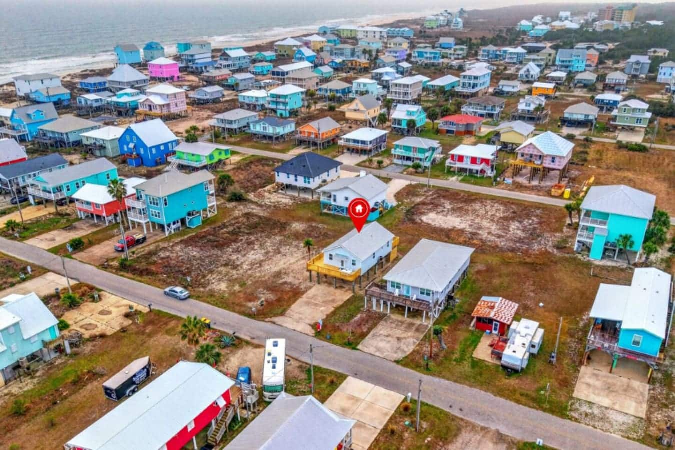 Beachfront community with colorful elevated homes and ocean views just steps away.