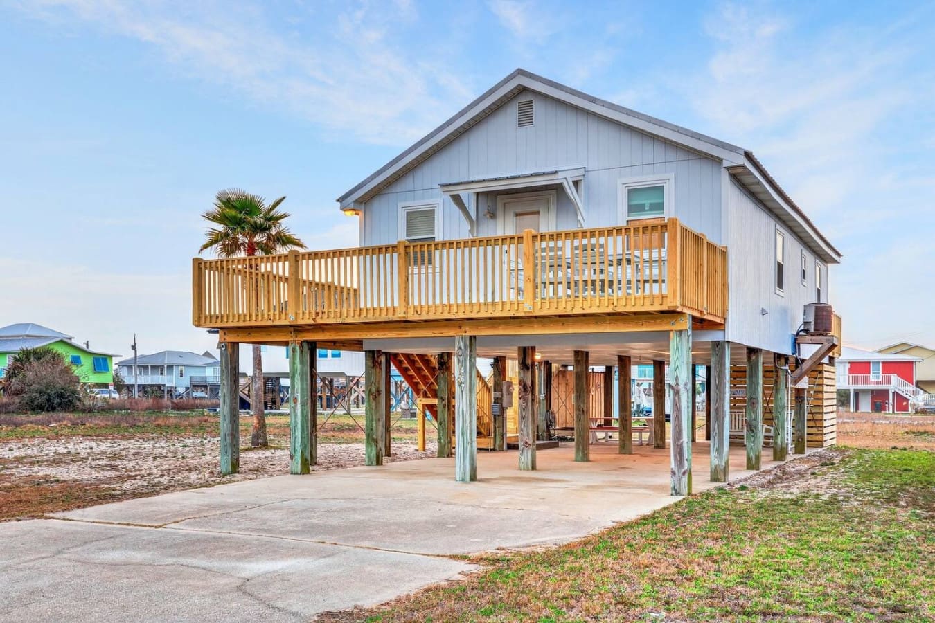 This elevated beach house sits right on the sand with a huge wraparound deck perfect for taking in the coastal views.
