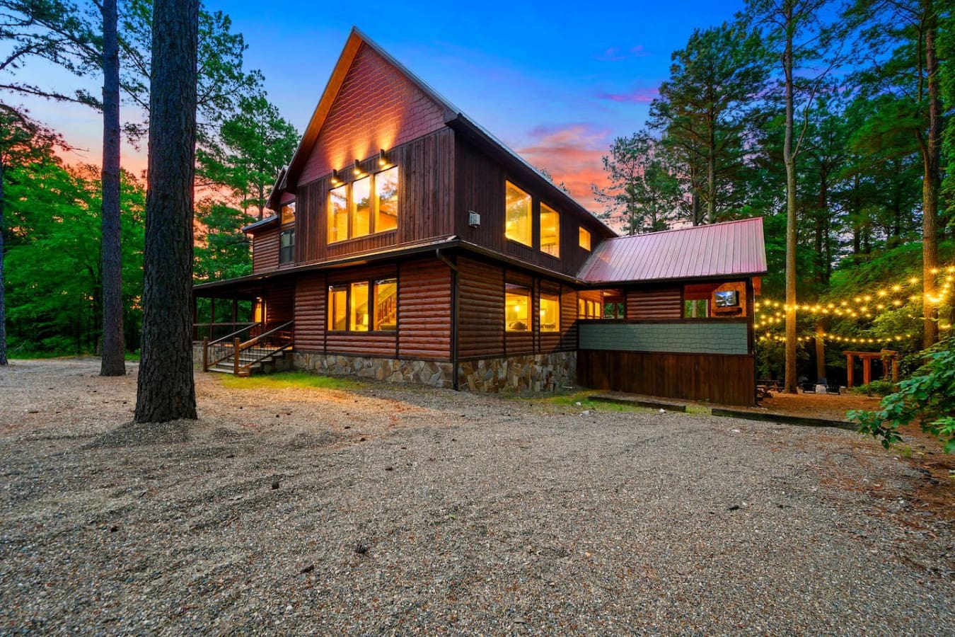 This cabin lights up at dusk and honestly just hits different—like you're staying somewhere that actually feels special, nestled in the woods but still totally livable.