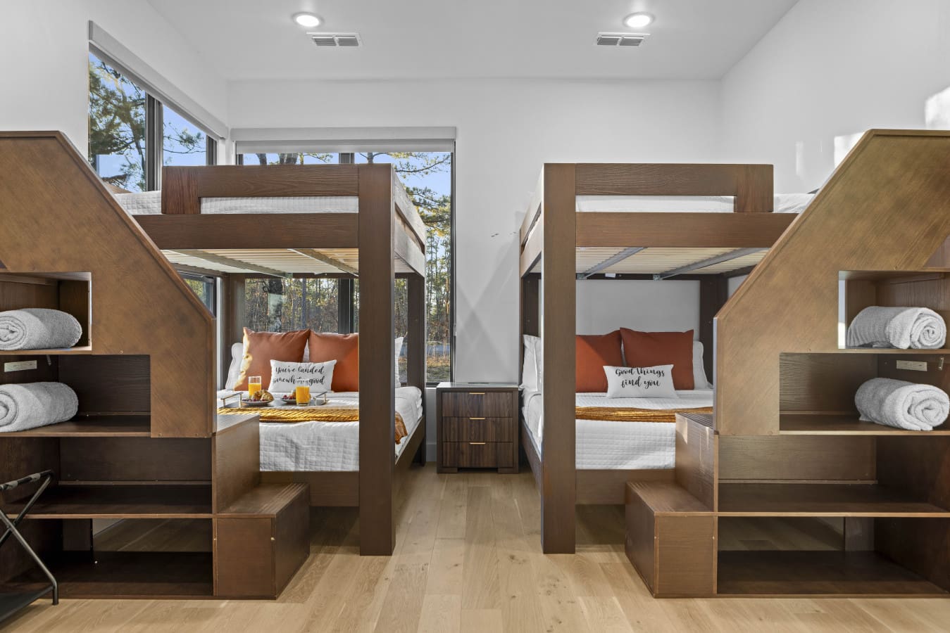 The bunk room sleeps eight with two queen-over-queen setups and built-in stairs for easy access to the top.