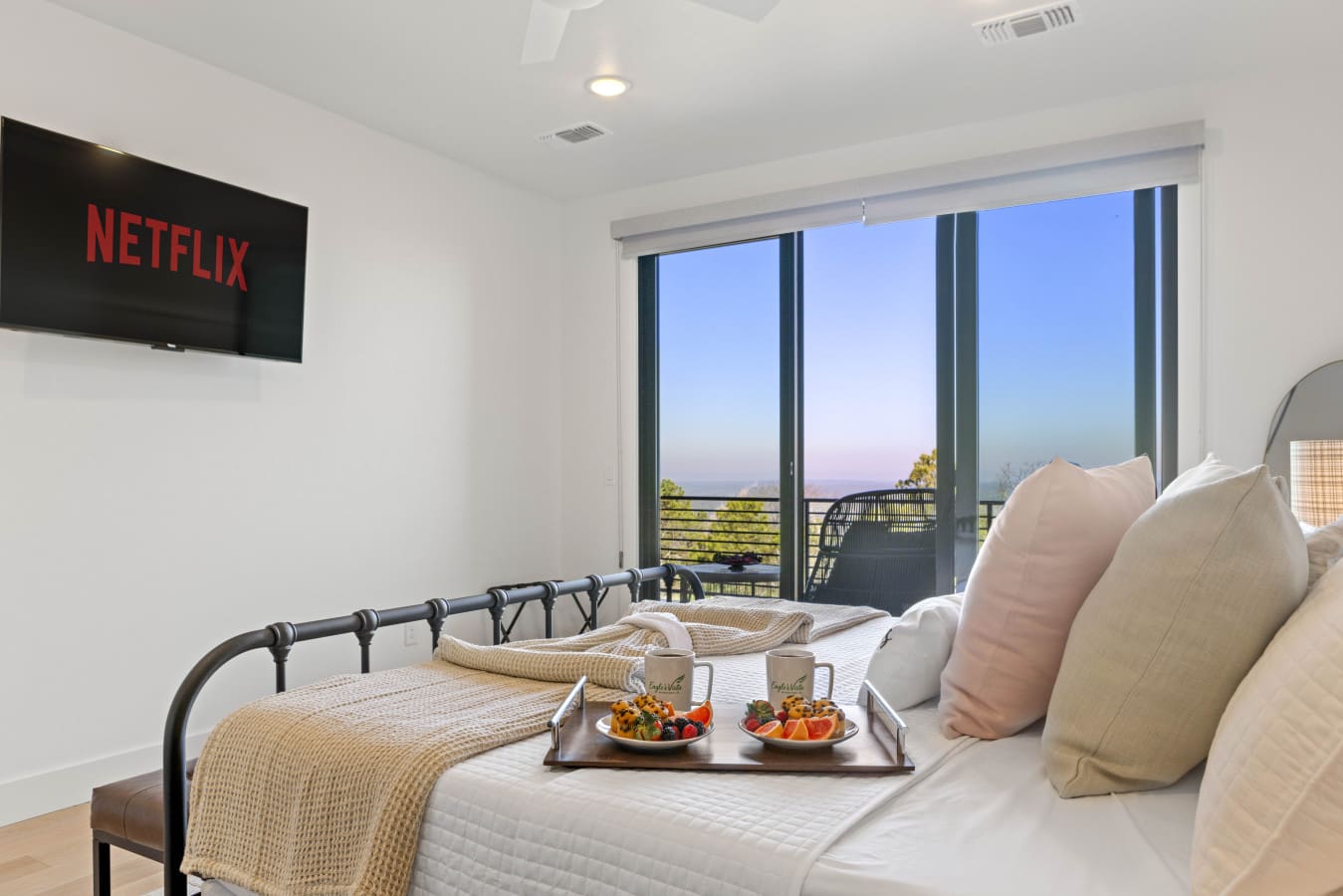 Cozy throw, sliding door views, and nowhere you need to be — mornings here are hard to leave.