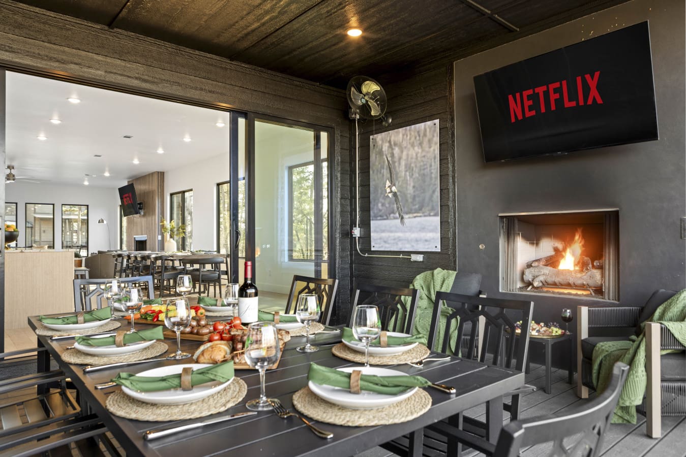 Outdoor dining by the fireplace with a full table setting and Netflix ready—this is how you do dinner at Eagle's Vista.
