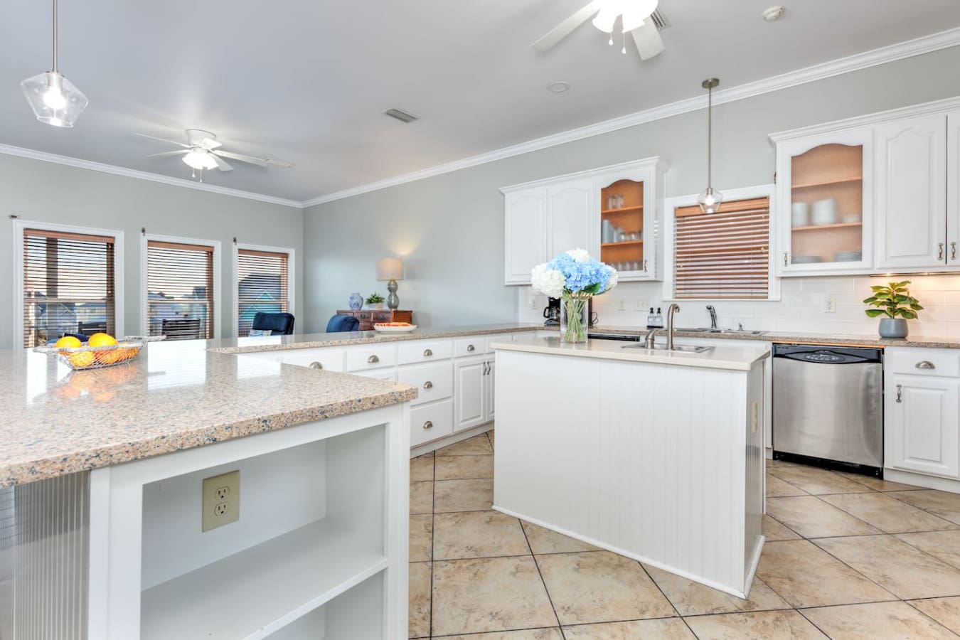 This spotless, light-filled kitchen with granite counters, white cabinetry, and those gorgeous glass-front cabinets is basically made for cooking up something amazing or just hanging out while someone else does the work.