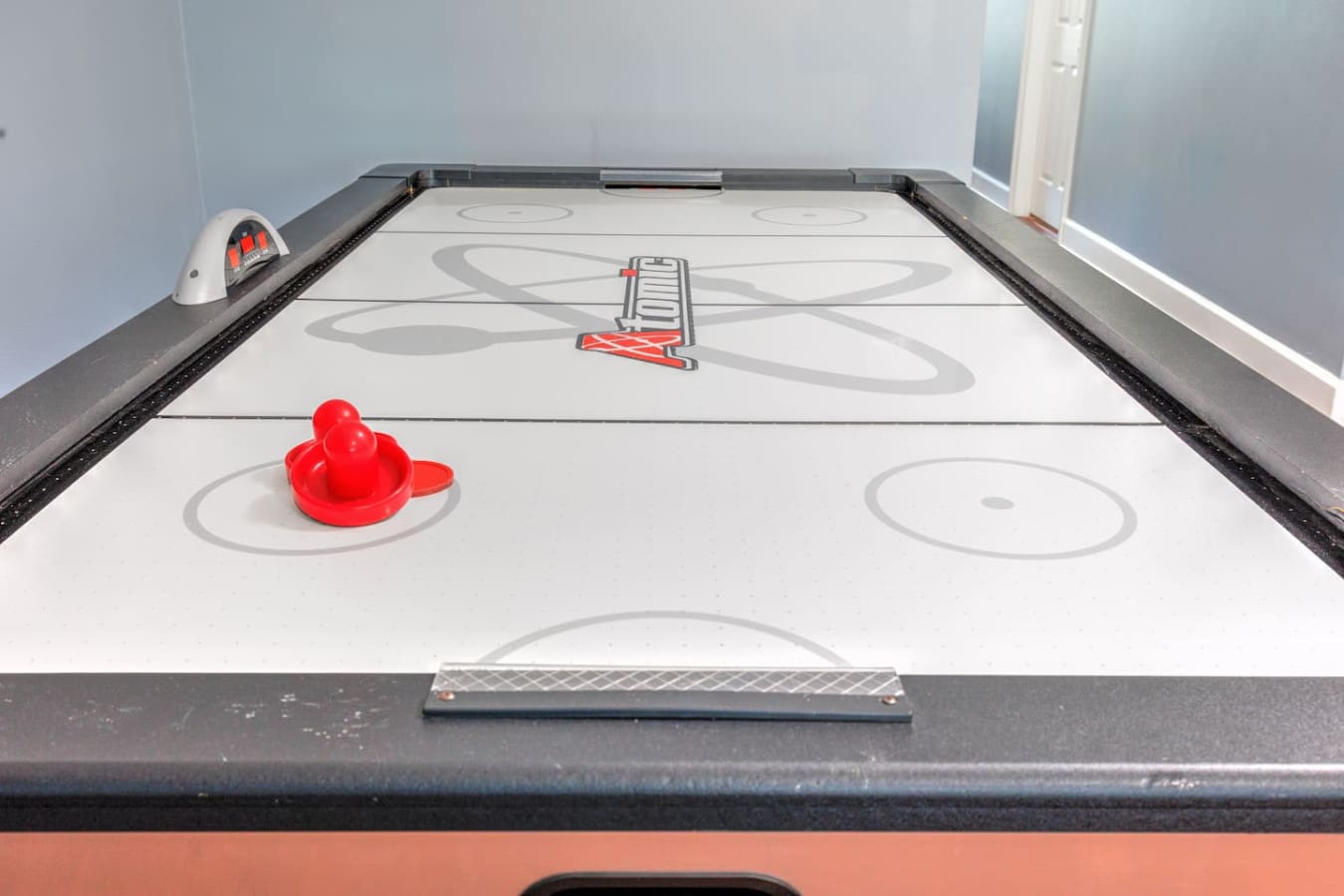 Whether you're crushing it at air hockey or just hanging out, this game room is basically your crew's new favorite spot for a little friendly competition.