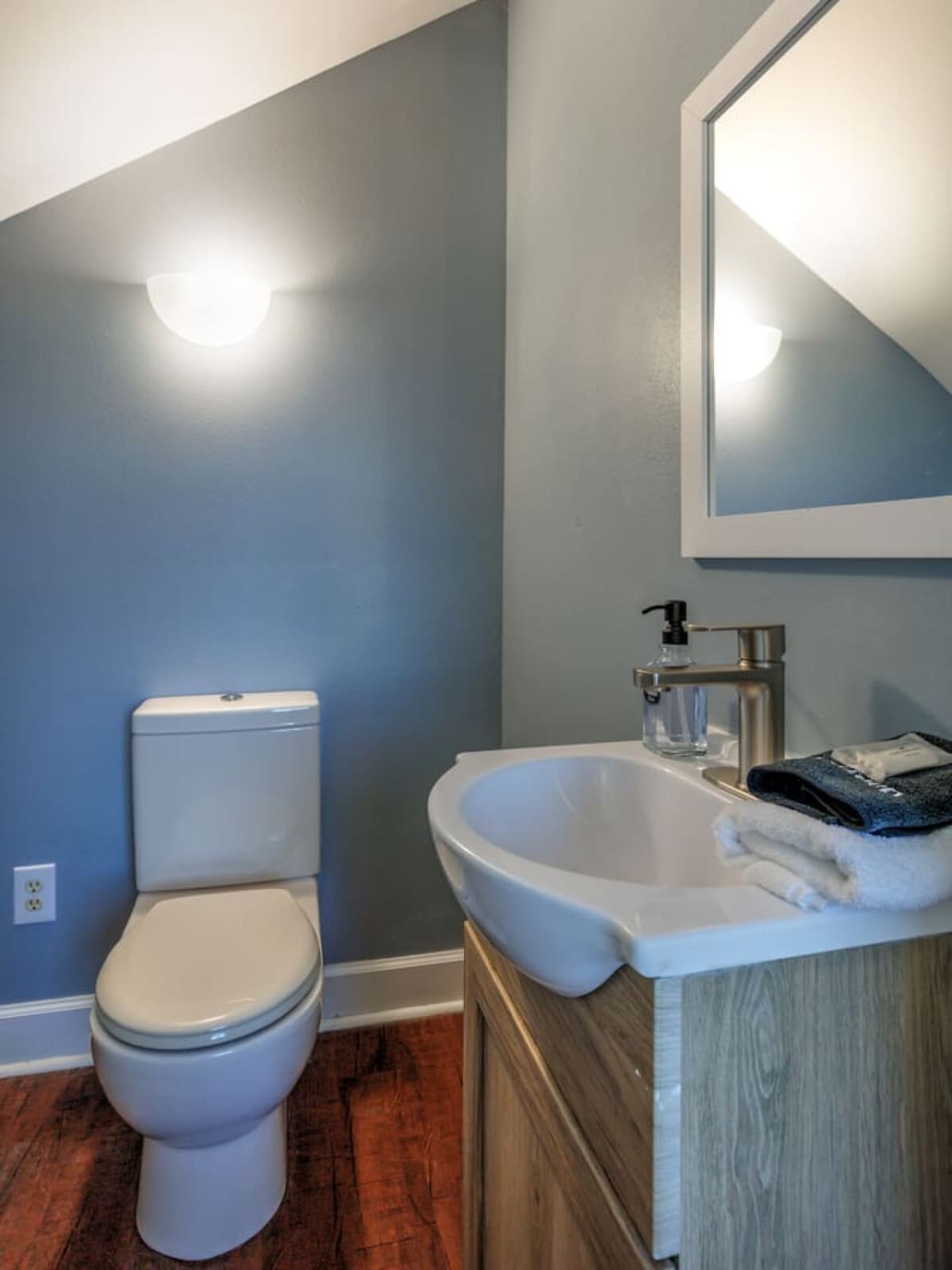 This fresh, modern bathroom with its calming blue walls and sleek fixtures is exactly the kind of clean, functional space that makes getting ready in the morning actually feel like part of the vacation.