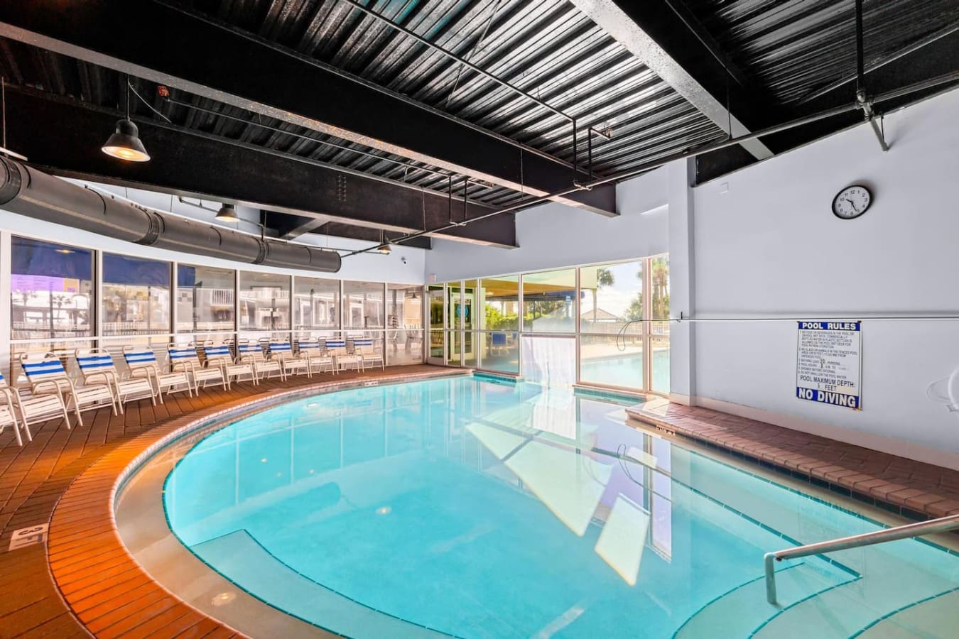 Dive into this indoor pool area and you've got the perfect spot to cool off when you need a break from the sun—floor-to-ceiling windows keep that ocean view in sight while you splash around in the heated water.