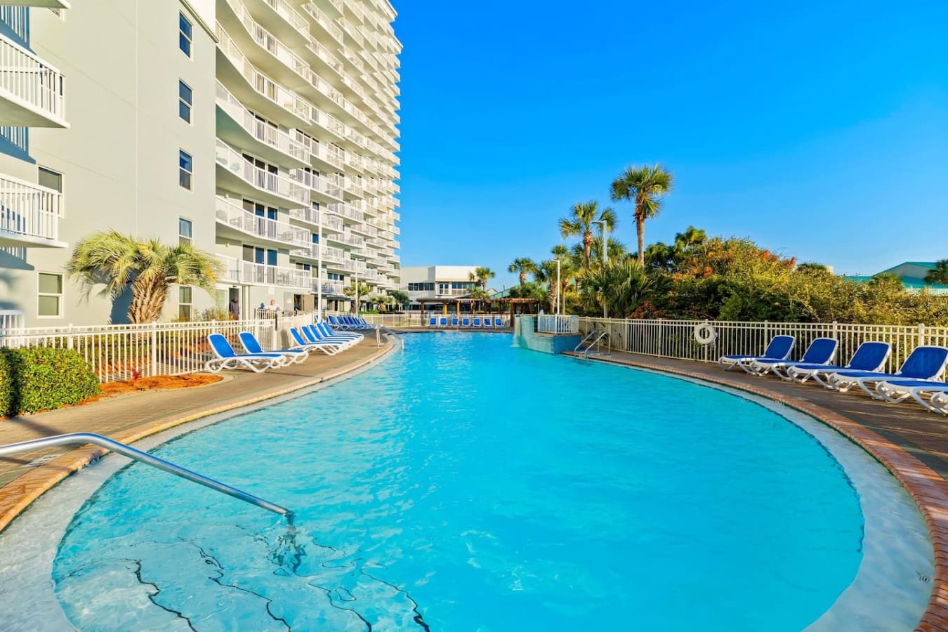 Dive into crystal-clear pool water that practically glows under the Florida sun while palm trees sway and that gorgeous high-rise backdrop makes you feel like you've scored the ultimate beachside escape.