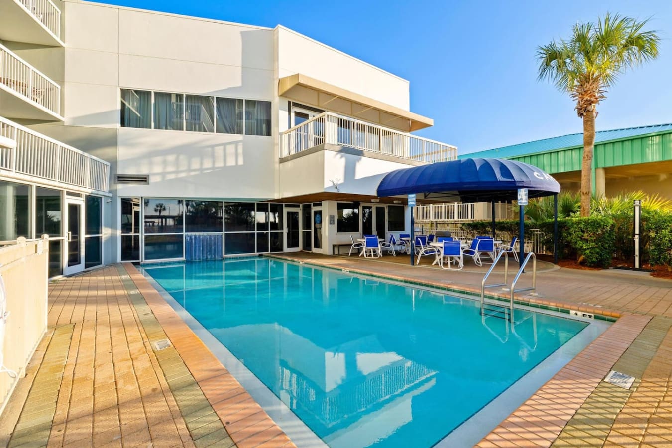 The pool area's got that sweet spot where you can lounge under the shade, watch the water shimmer in the sun, and still feel that oceanfront energy without leaving your chair.