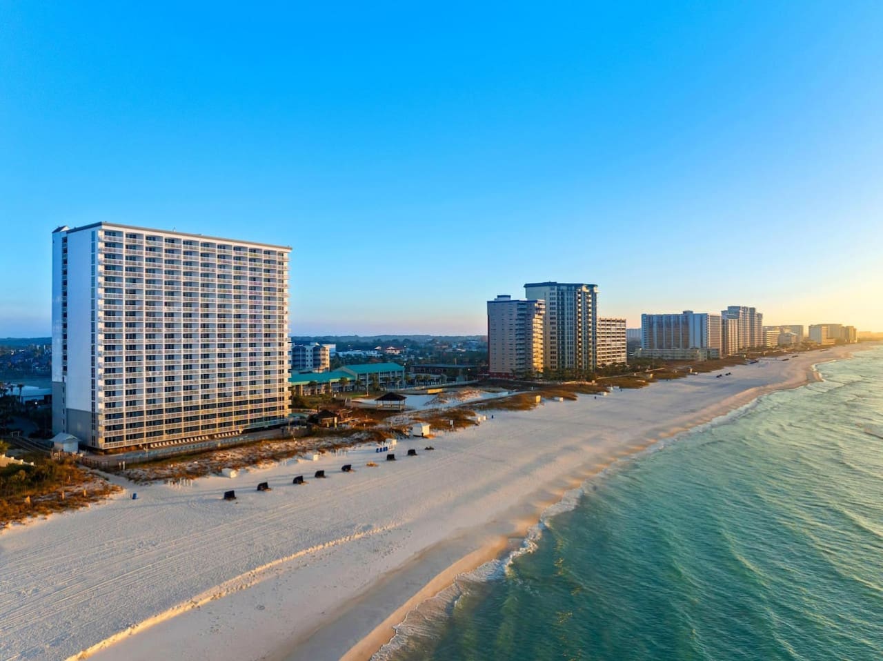 Watching the sun paint those high-rises golden while the waves roll in and the whole beach stretches out in front of you—this is basically what every beach vacation daydream looks like.