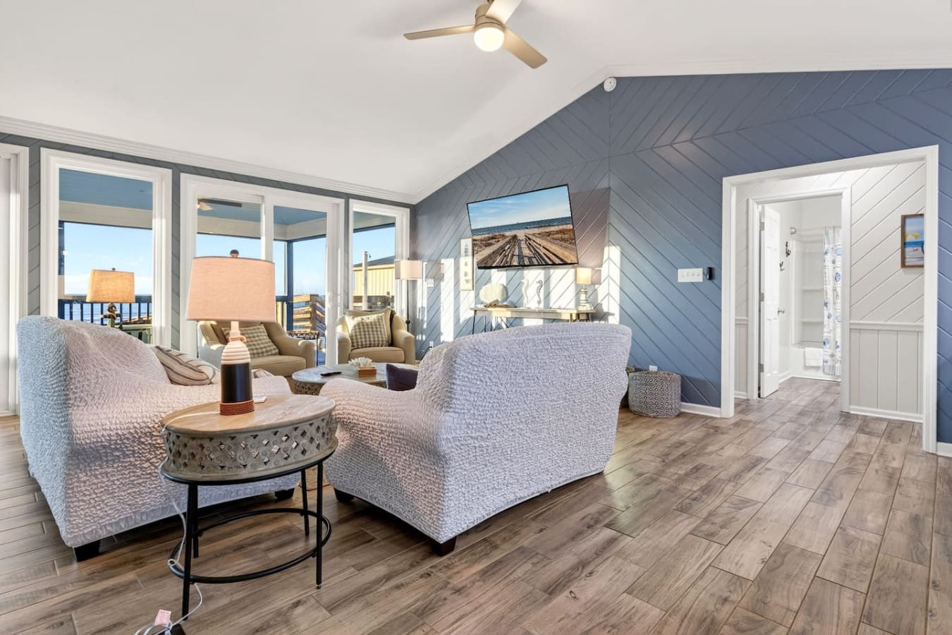 This spacious master suite features stunning views, a cozy seating area, and direct access to a private balcony overlooking the countryside.