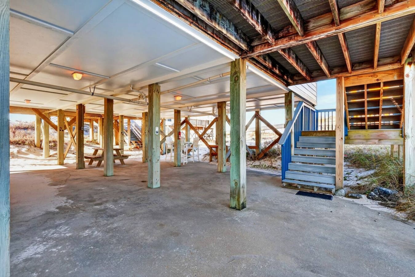 Covered beachside pavilion with weathered wood beams and plenty of open space for gatherings.
