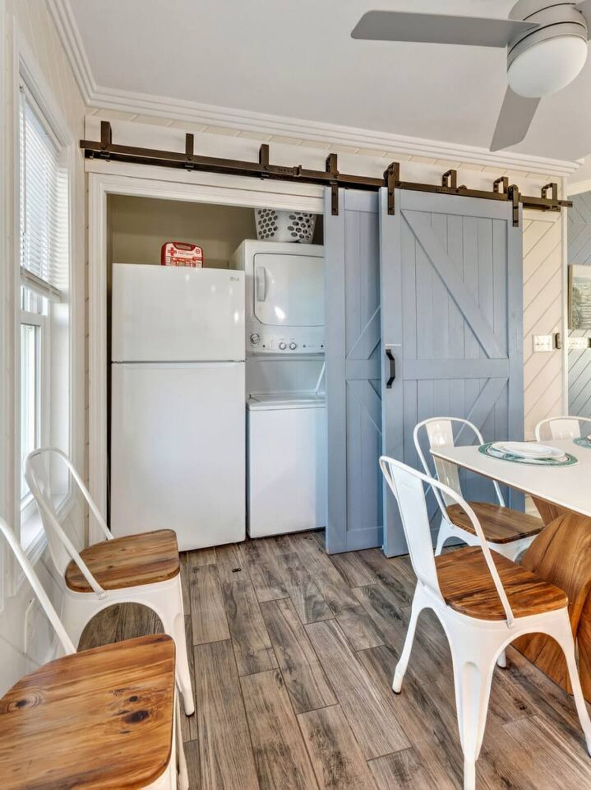 Bright and efficient kitchenette with full-size appliances and sliding barn doors opening to your dining area.