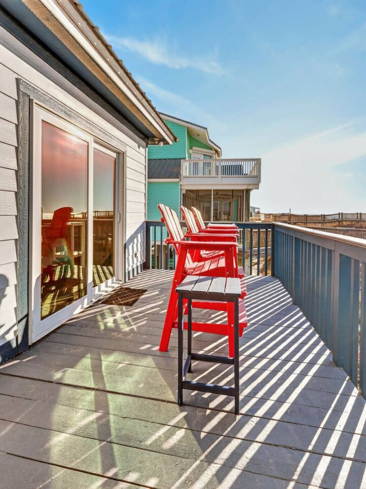 Wake up to oceanfront views and your morning coffee on this spacious private deck with plenty of seating.