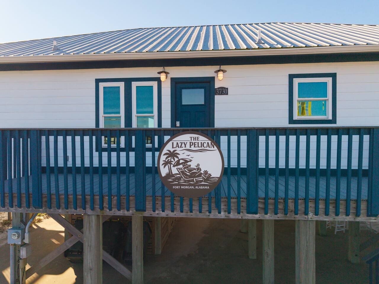 This charming elevated beach cottage features a covered deck with great views and classic coastal architecture.