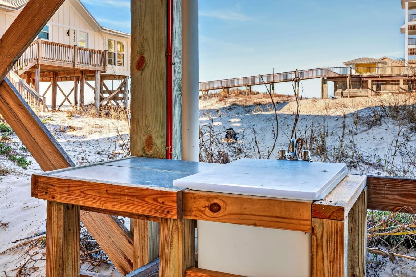 Wake up to oceanfront views from your private beach house with direct sand access and neighboring dune homes.