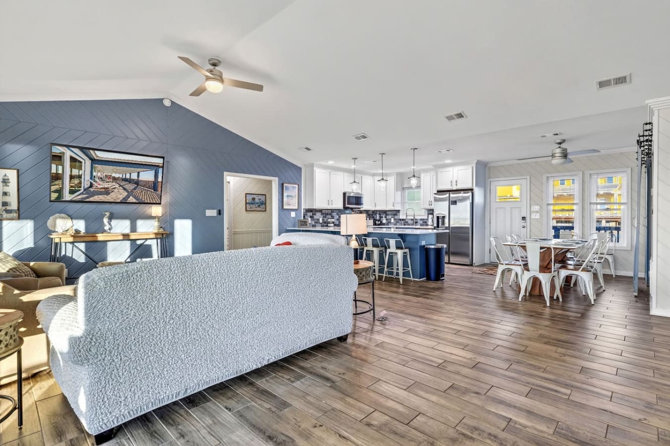 This open-concept living space flows seamlessly from the cozy seating area through the modern kitchen and dining zone with gorgeous water views.