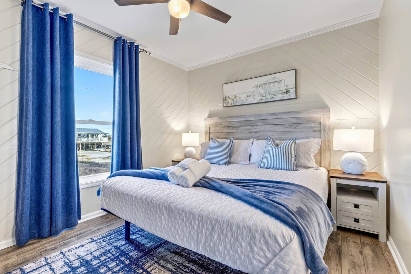 This bright master bedroom has stunning water views and a ceiling fan to keep you cool while you sleep.