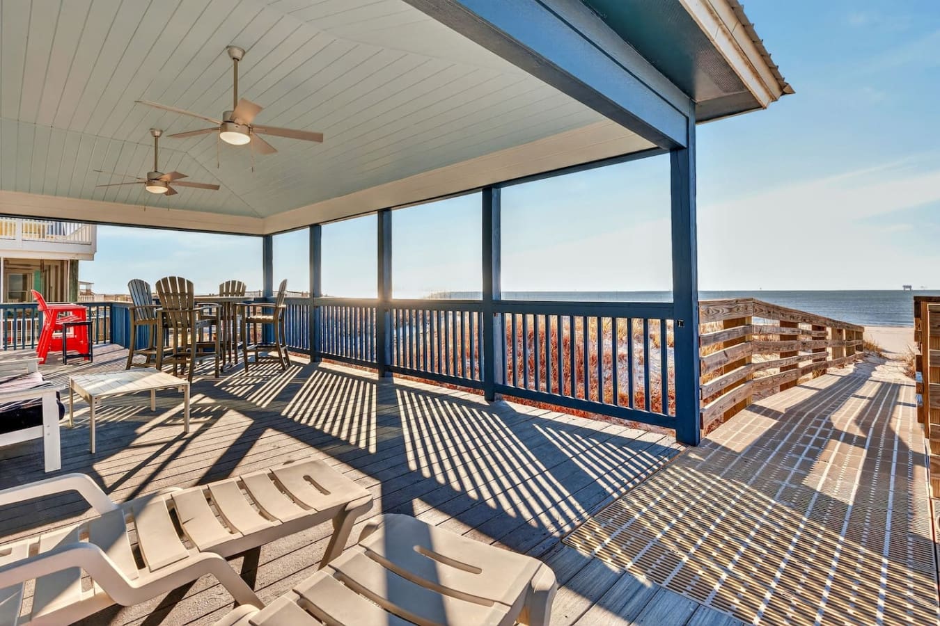 Wake up to oceanfront views from this screened porch with plenty of lounge chairs and ceiling fans.