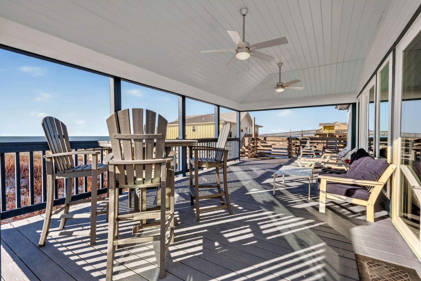 This covered oceanfront deck is basically the ultimate hangout spot with endless views and fans to keep you comfortable year-round.