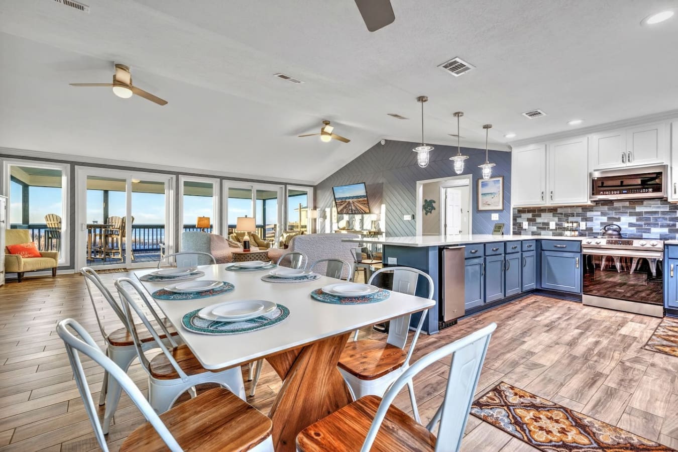 This gorgeous open-concept kitchen and dining area flows seamlessly into a living room with stunning ocean views.