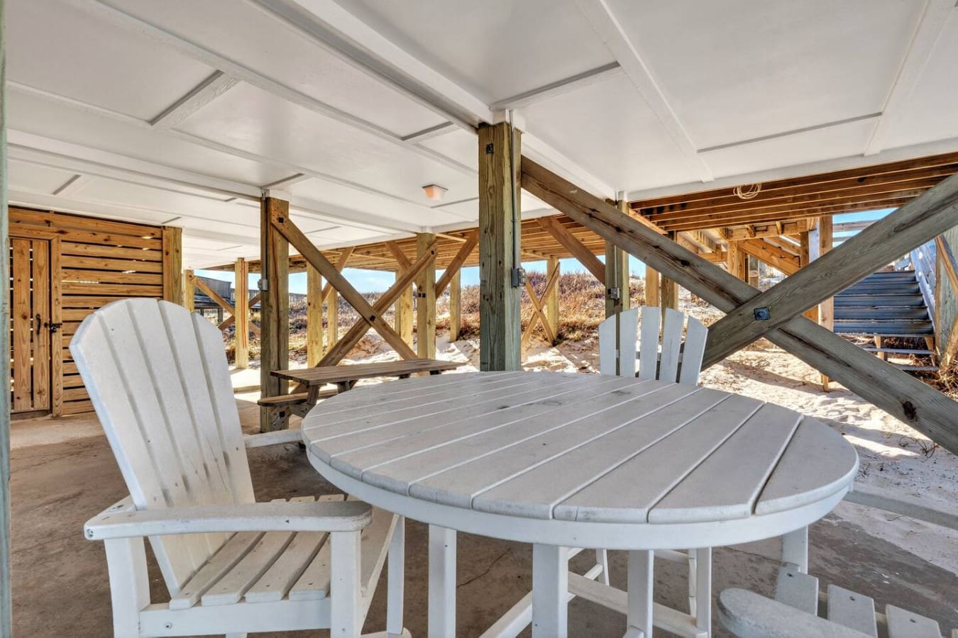 Covered oceanside pavilion with Adirondack seating and timber beams perfect for enjoying the views.