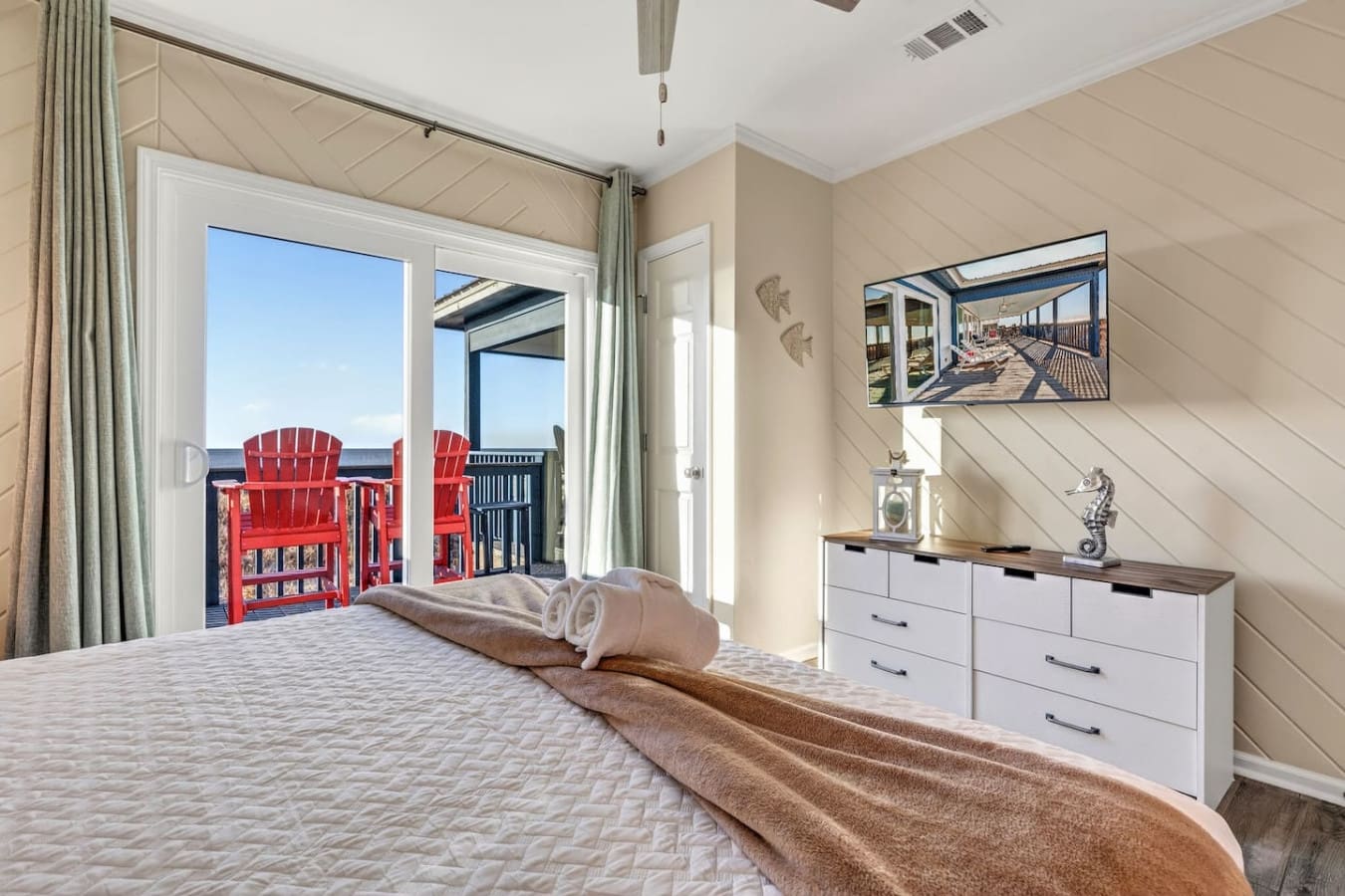 Wake up to ocean views and direct deck access with those iconic red Adirondack chairs right outside your door.