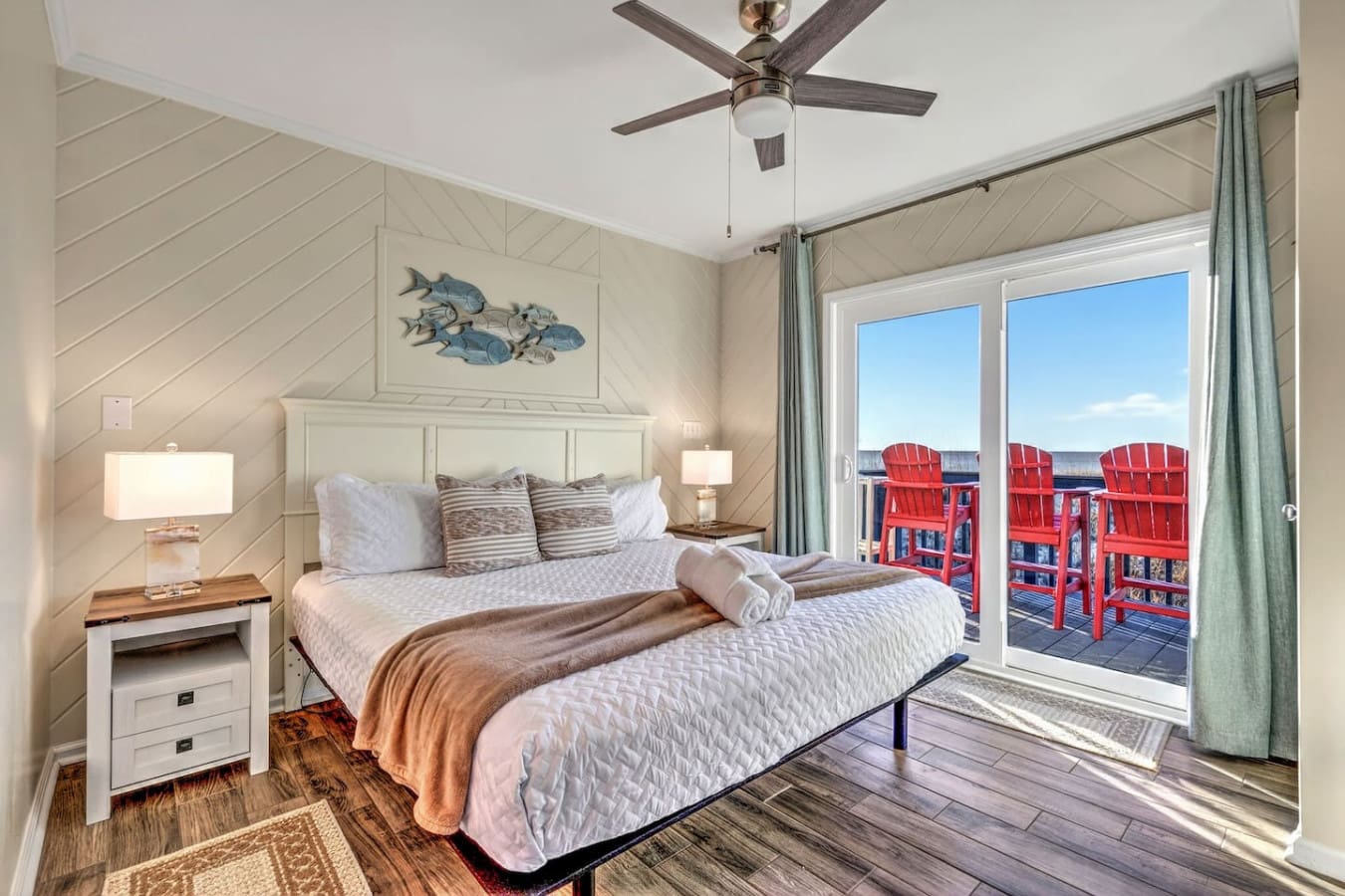 Wake up to those stunning water views and red Adirondacks from your private bedroom deck.