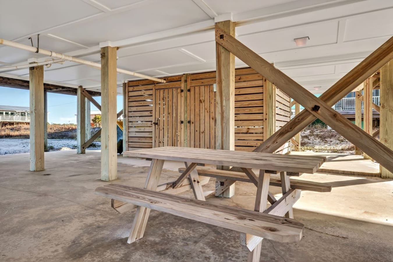 Covered pavilion with picnic tables and waterfront views, perfect for gatherings and outdoor relaxation.
