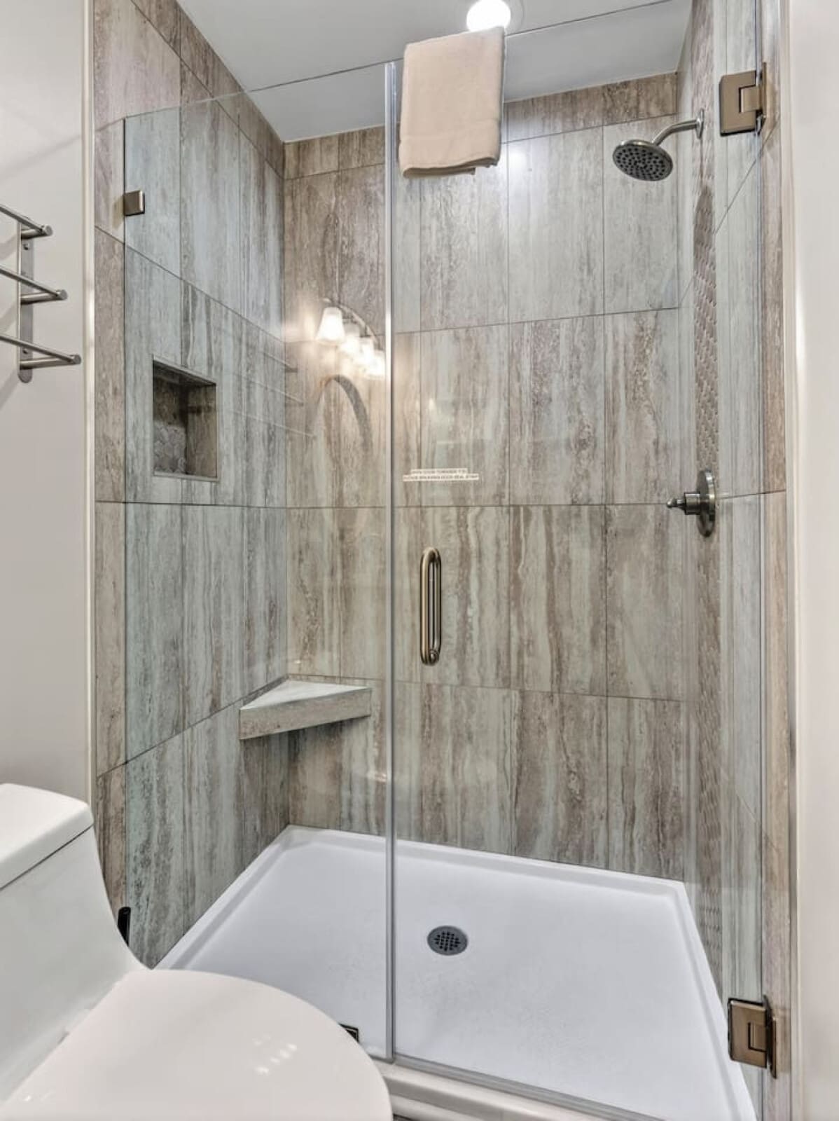 This spa-like shower with rainfall showerhead and heated floors feels like a luxury hotel bathroom.
