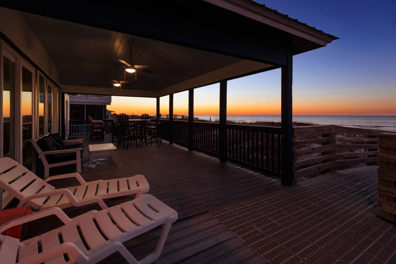 Watch the sunset paint the sky while lounging on this sprawling oceanfront deck with covered seating for the whole crew.