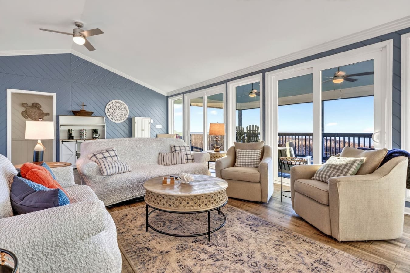 This oceanfront living room is basically designed for lounging with those huge windows and killer water views.