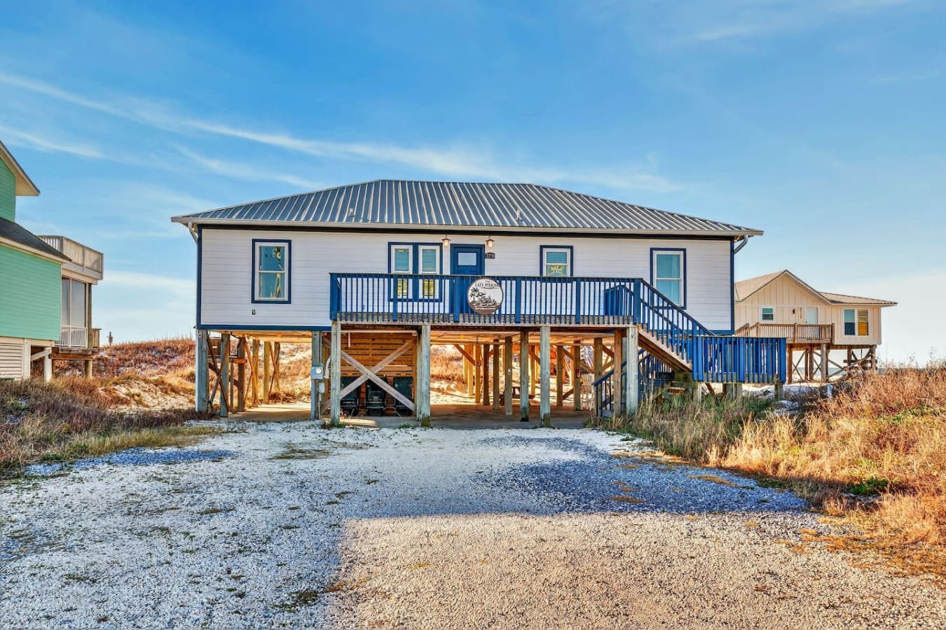 This elevated beach house offers modern coastal living with direct access to the dunes and a spacious covered deck perfect for taking in the views.