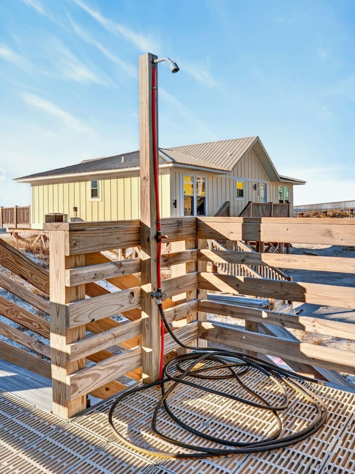 This beachfront home features an outdoor shower with ocean views and direct access to the sandy beach.