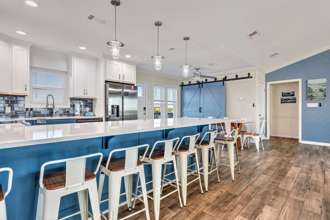 This stunning kitchen and dining space features premium stainless steel appliances, a spacious island, and plenty of room for the whole crew.