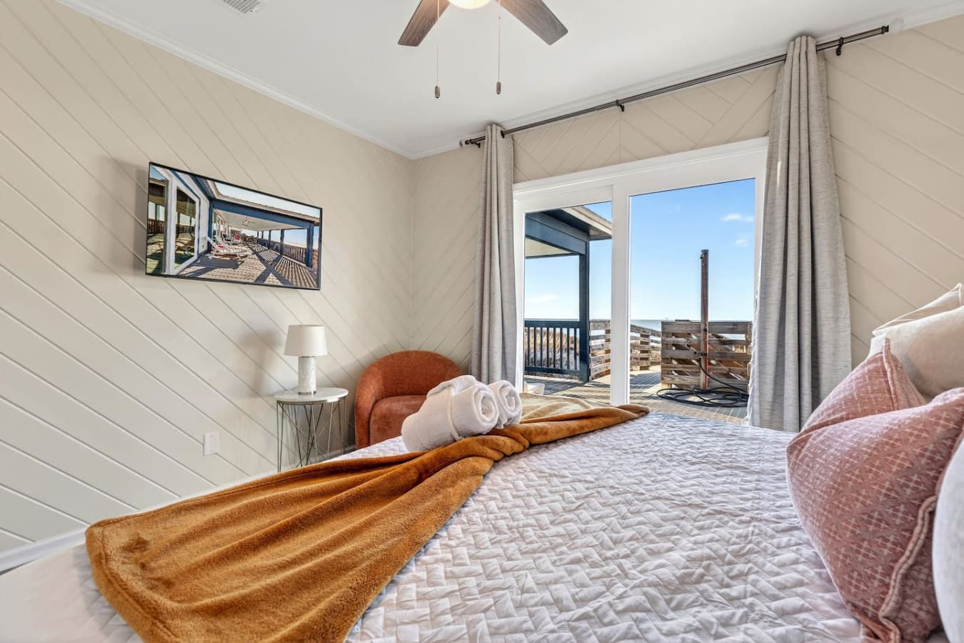Wake up to panoramic ocean views from this stunning beachfront bedroom with direct deck access.