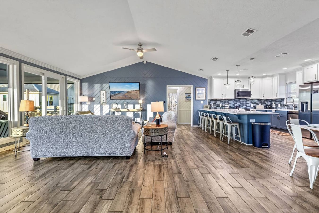 This open-concept living space flows seamlessly from the cozy lounge to the chef's kitchen with stunning coastal views.