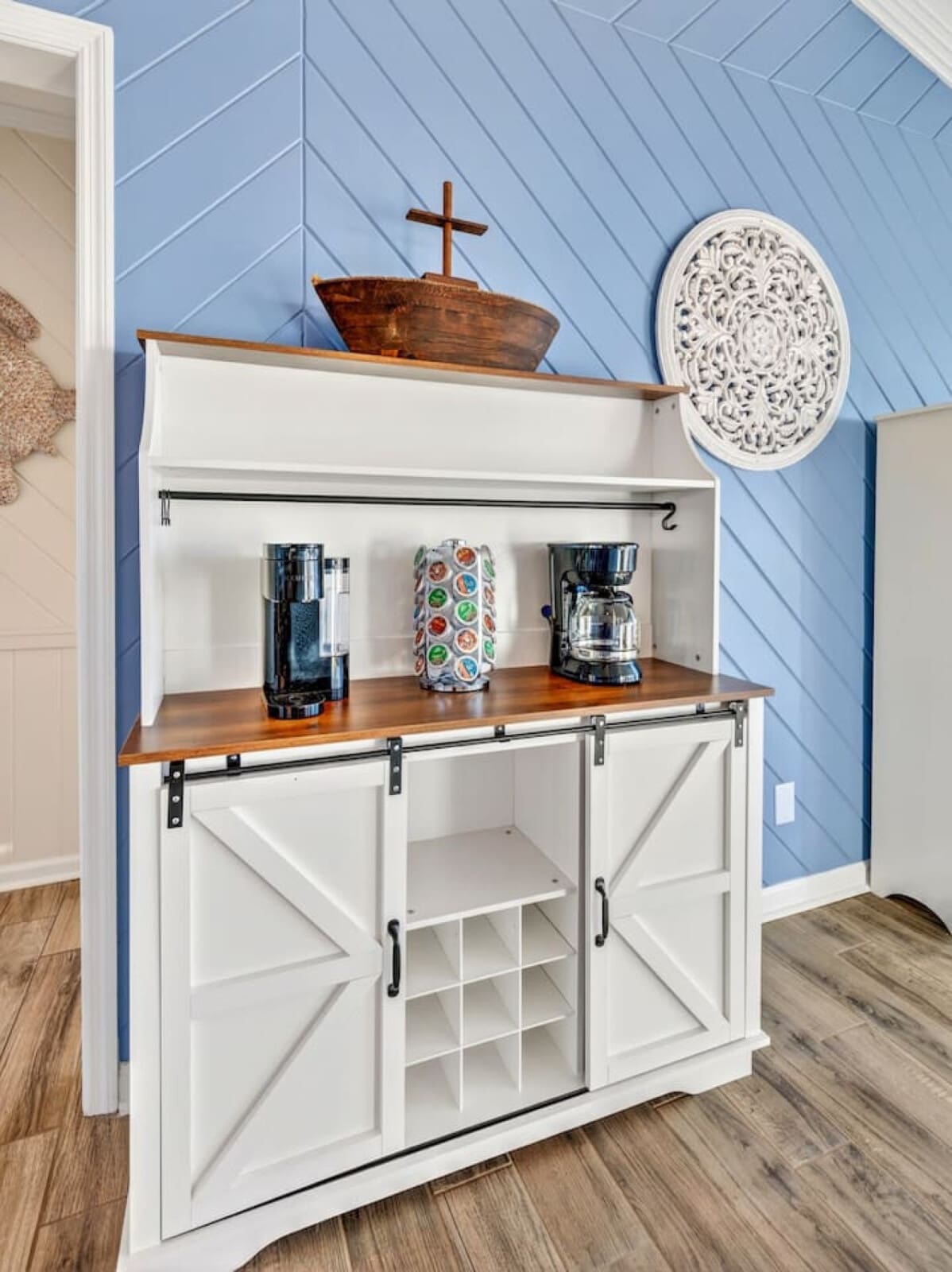 This charming built-in bar features sliding barn doors, warm wood countertops, and plenty of storage for entertaining.