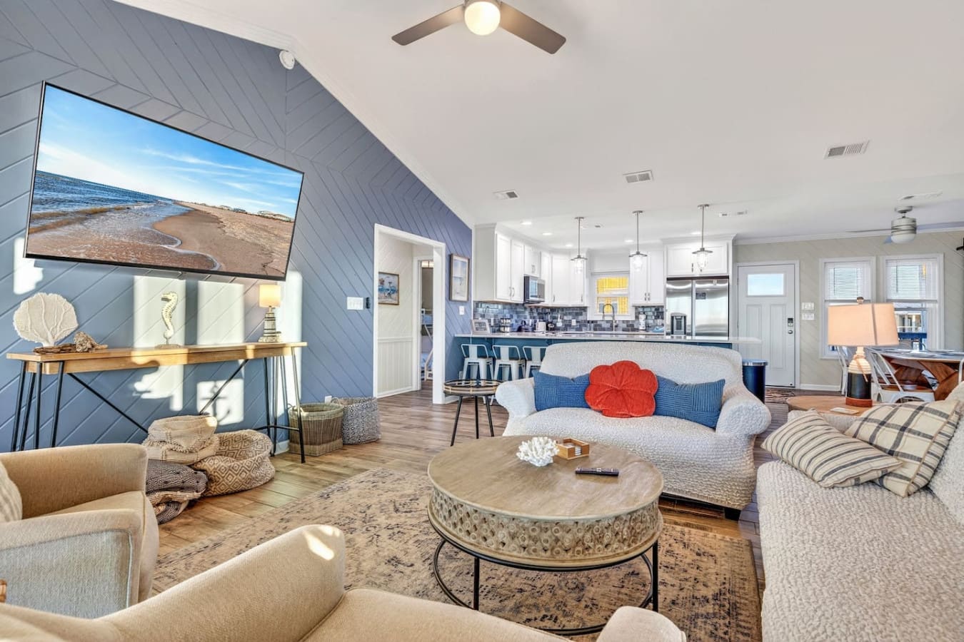 This open-concept living area is perfect for gathering with incredible natural light and easy flow between the kitchen and lounge spaces.