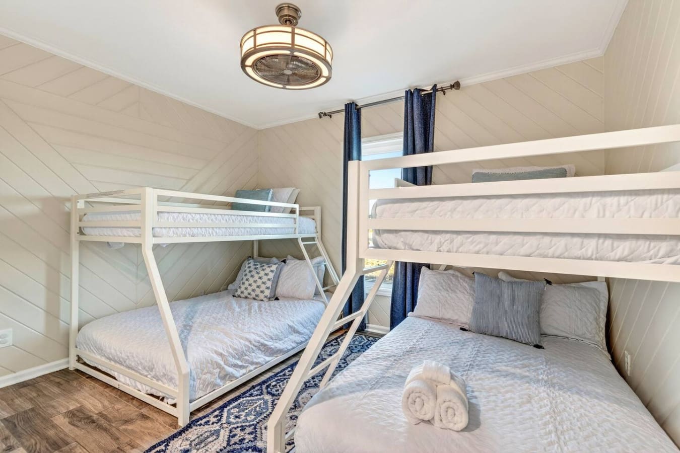 This bright upstairs bedroom has tons of sleeping space with a bunk bed and a queen, perfect for families.