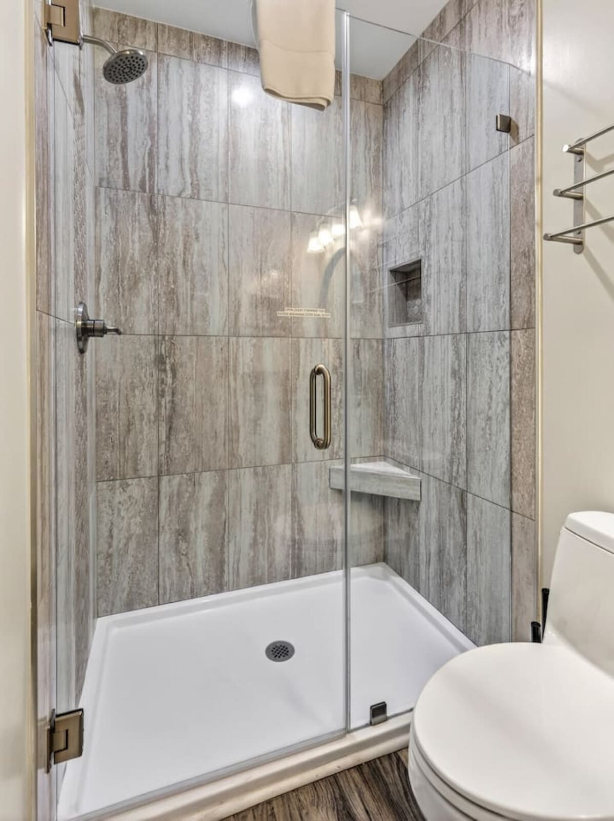 This spa-like shower with gorgeous gray tile and rainfall showerhead is basically a daily luxury experience.