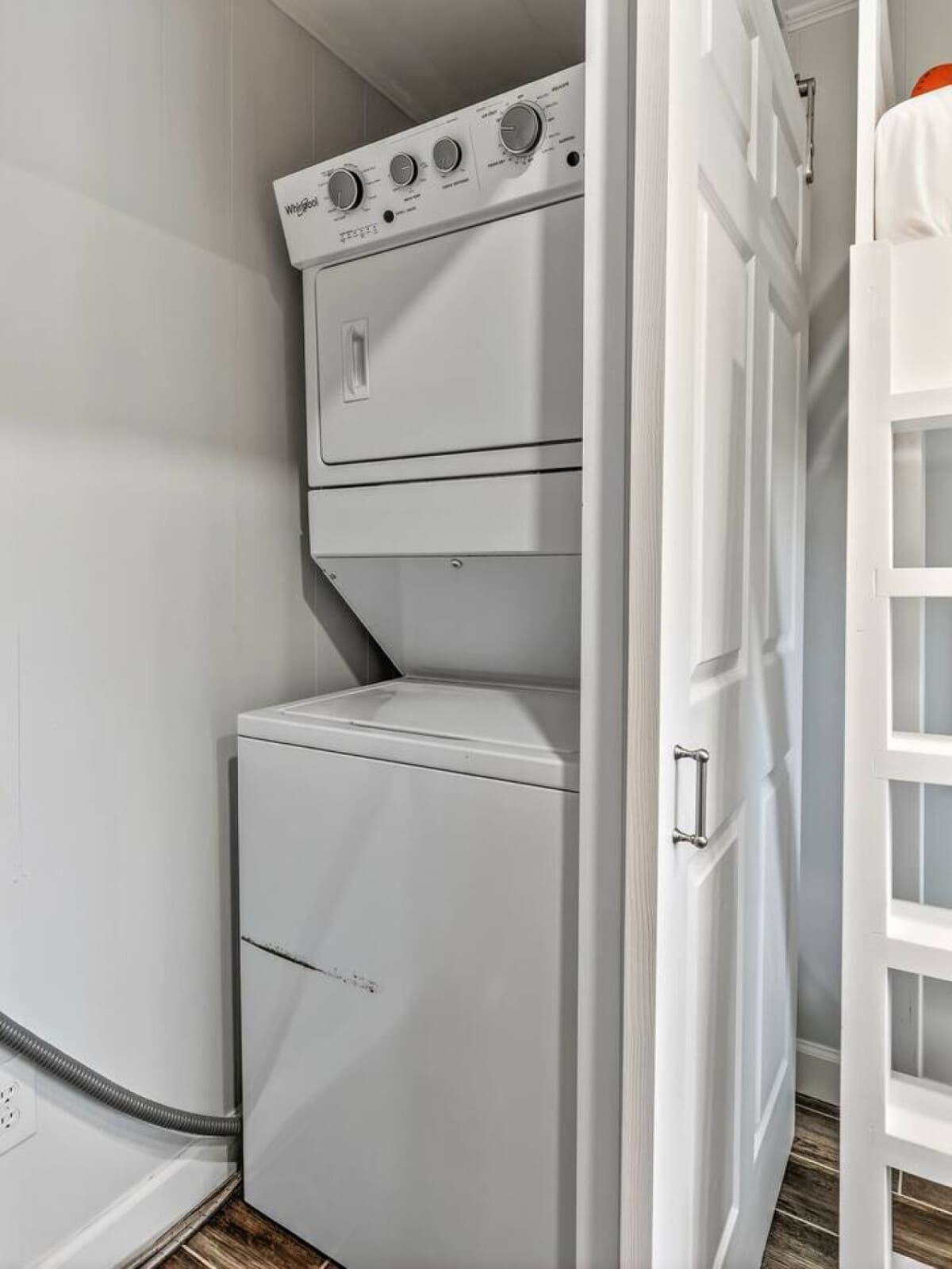 Stacked washer and dryer combo tucked neatly in the laundry closet for your convenience.