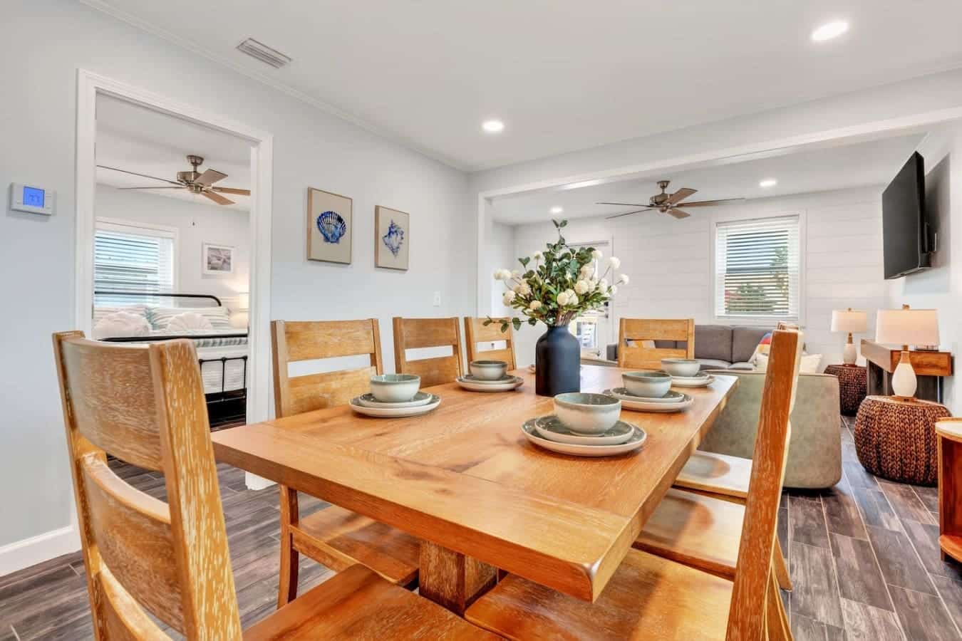 Open-concept living with a beautiful wood dining table that seats plenty of guests comfortably.