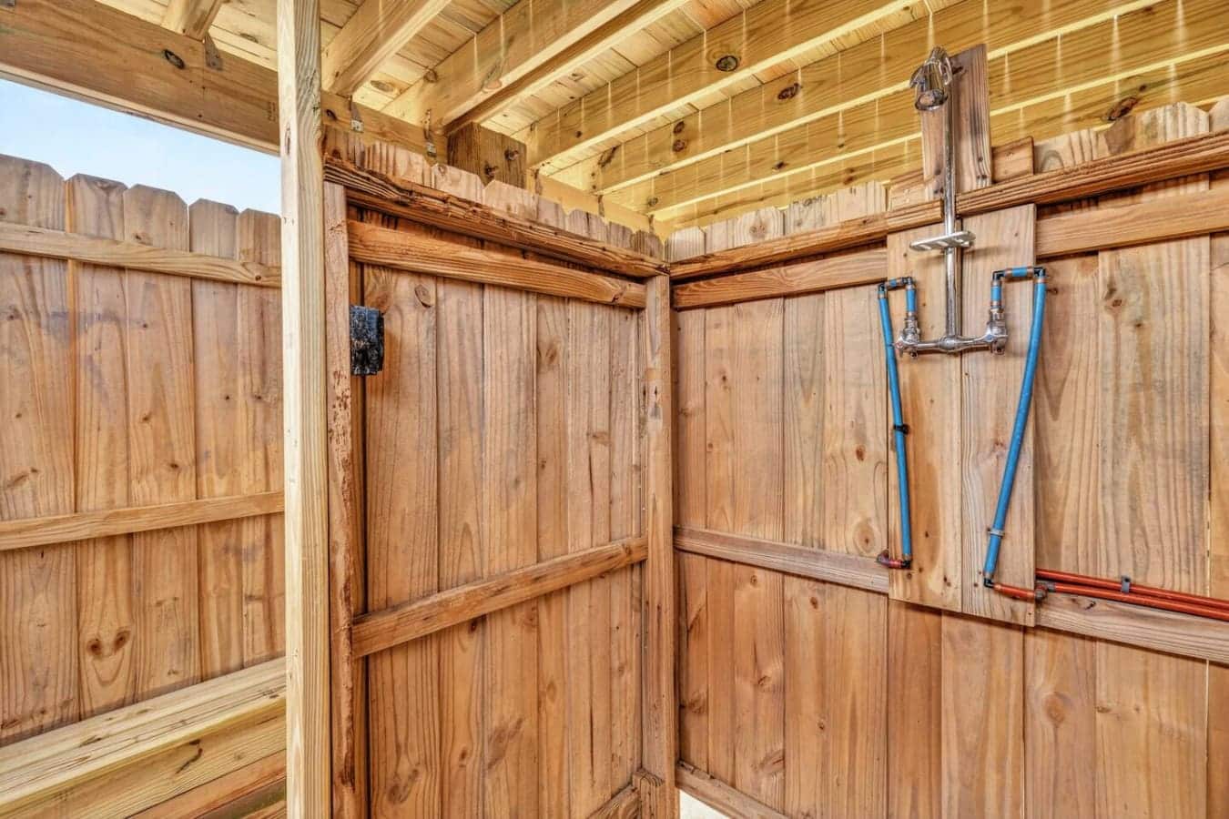 This gorgeous wooden barn structure features exposed beams, metal piping, and plenty of space for storage or a creative project setup.