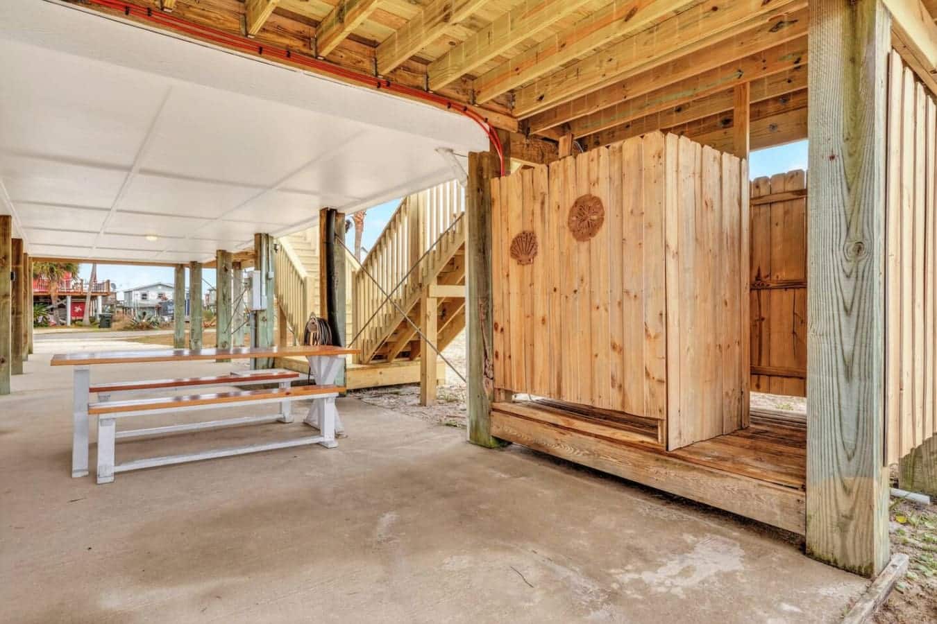 This covered pavilion space is perfect for outdoor gatherings with rustic wooden beams and plenty of room to relax.