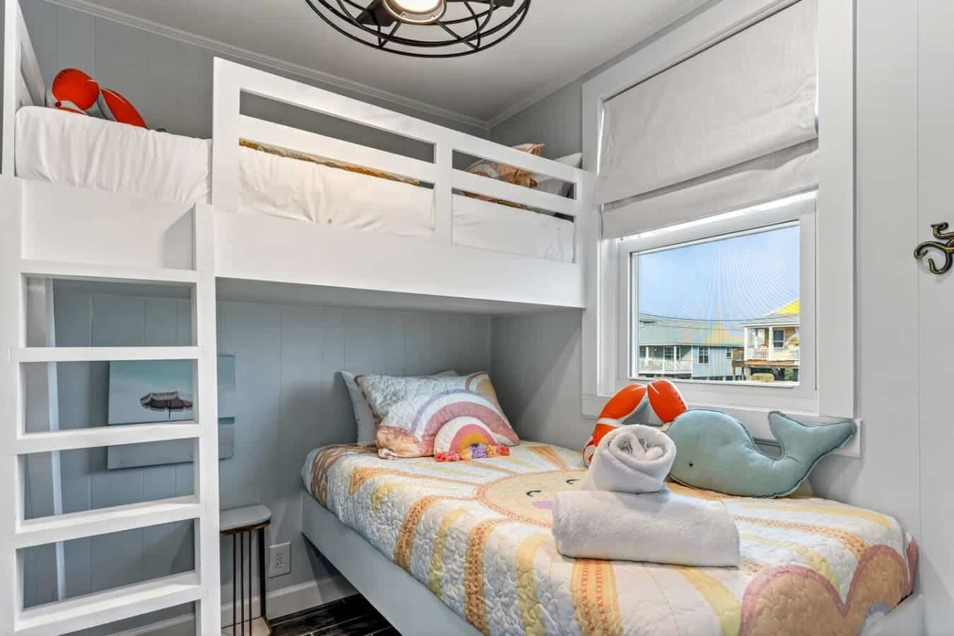 This cozy bunk room is perfect for kids with a window view of the neighborhood and plenty of storage.