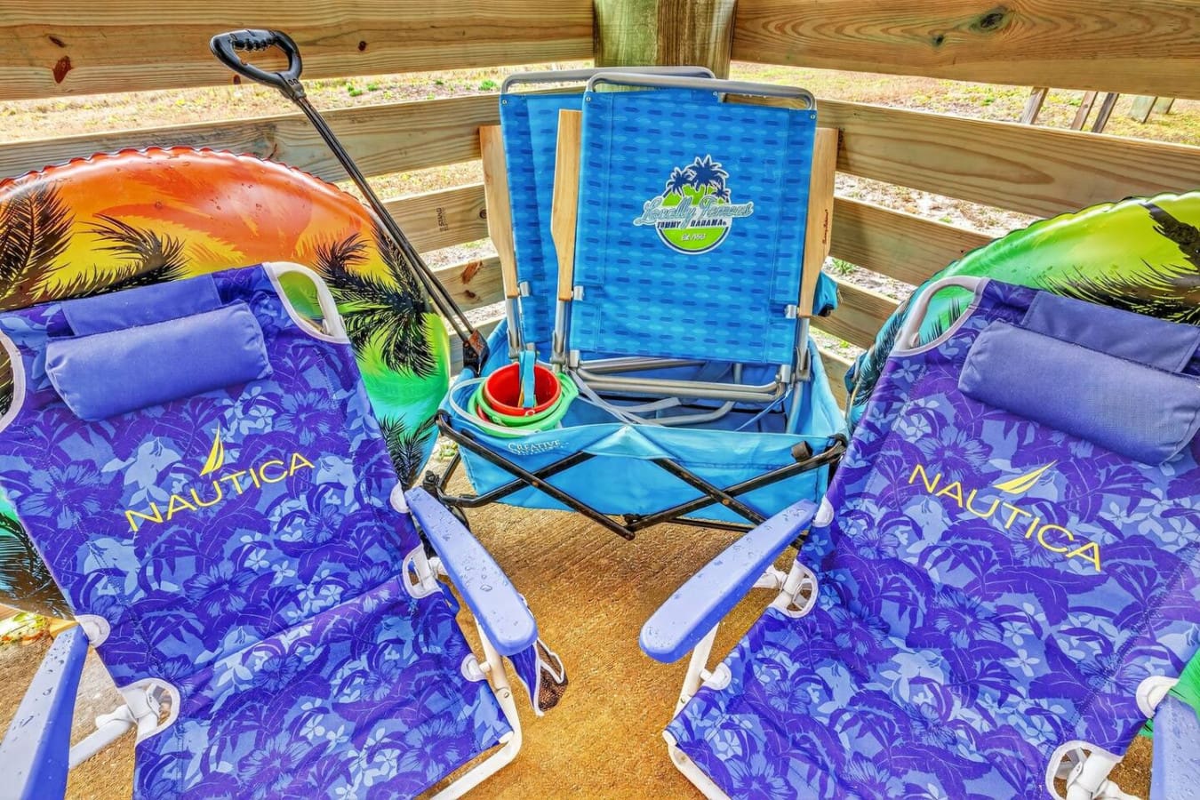 Covered beach pavilion with colorful lounge chairs and games perfect for days relaxing by the water.