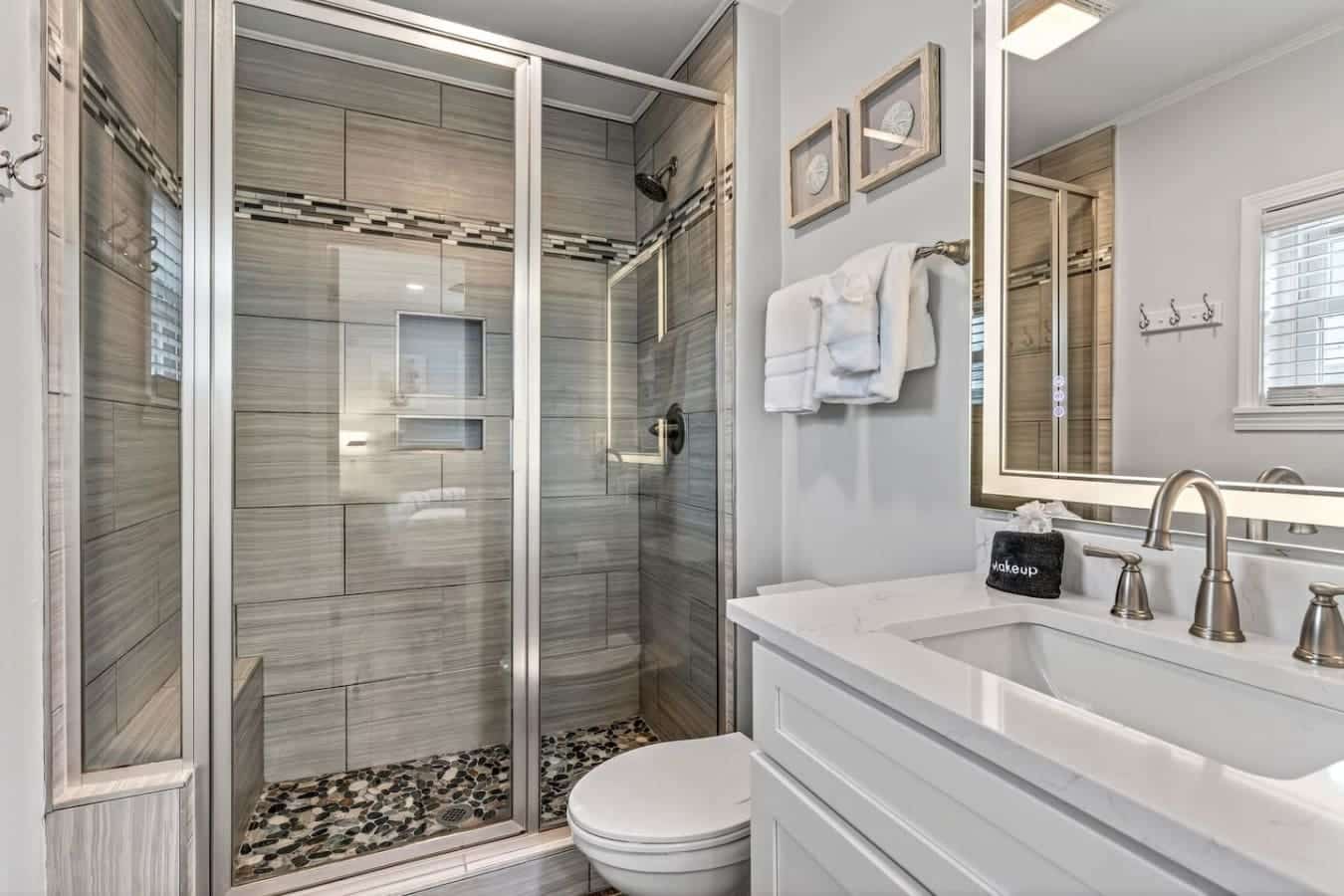 This spa-like master bath features a walk-in shower with gorgeous gray tile and a luxe double vanity.