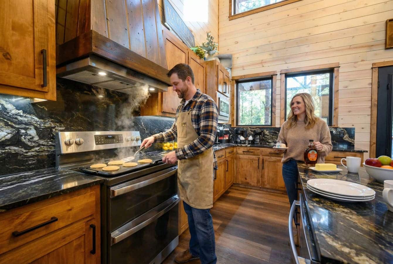 This chef's kitchen features custom wood cabinetry, marble countertops, and stainless steel appliances perfect for preparing meals during your stay.